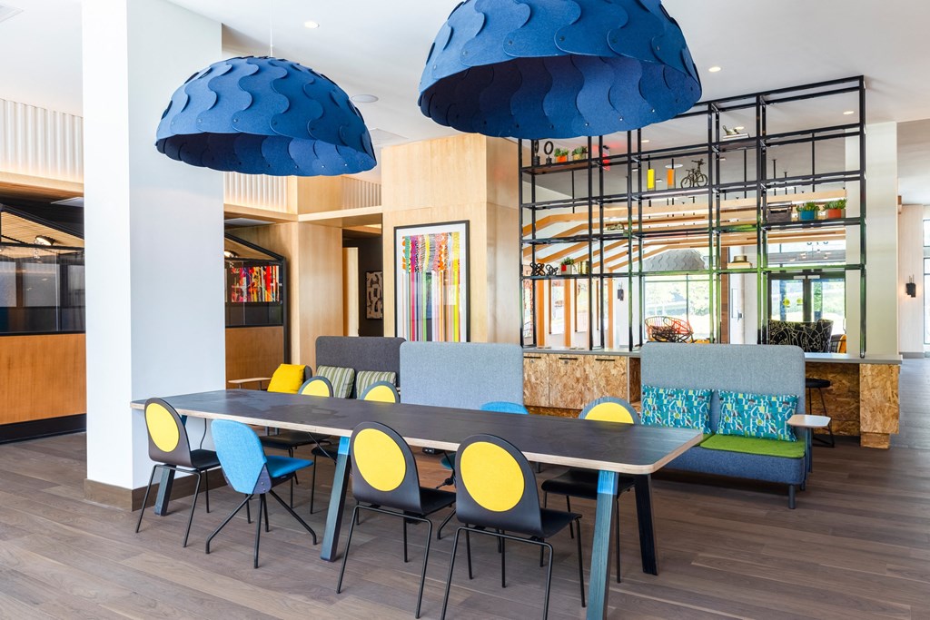 a dining room with blue chairs and a long table with chairs a dining room with blue chairs and a long table with chairs at The Chase at Bryant Street, Washington, DC