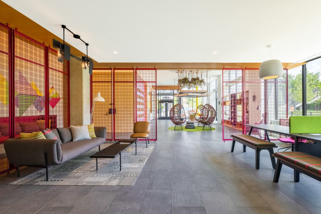 a living room with a couch and chairs and a ping pong table at The Chase at Bryant Street, Washington District of Columbia