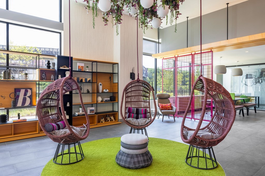 a lobby with two rattan chairs and a green rug at The Chase at Bryant Street, Washington District of Columbia