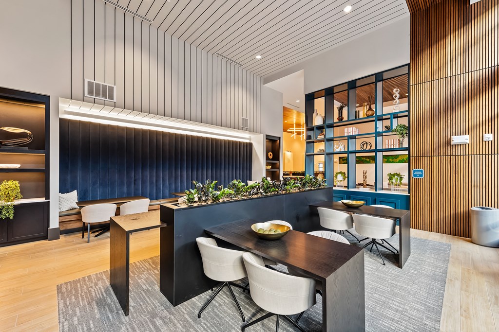 Modern dining and coworking area with a dark table and chairs  at Preston Ridge in Cary, NC.
