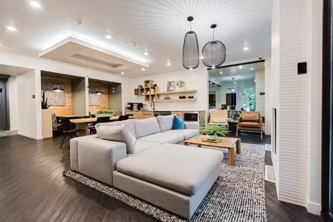 A modern living room with a grey sofa and a wooden coffee table.
