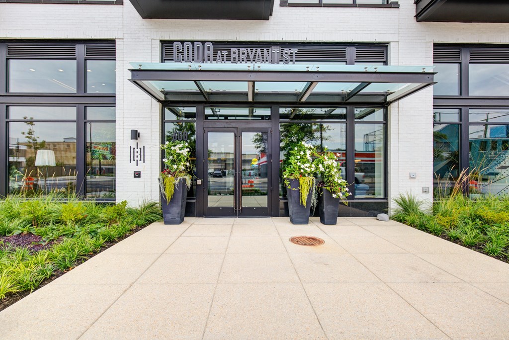 the front of a building with glass doors and a walkway at Coda at Bryant Street, Washington, 20002