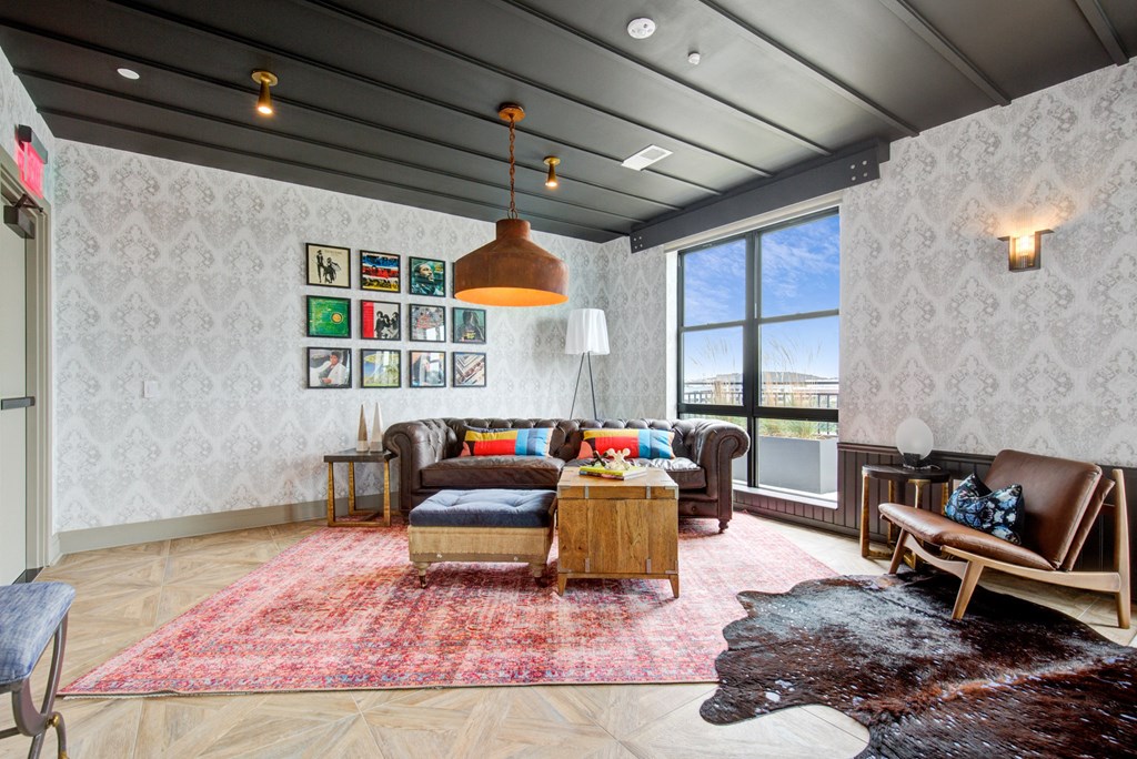 a living room with furniture and a large window at Coda at Bryant Street, District of Columbia
