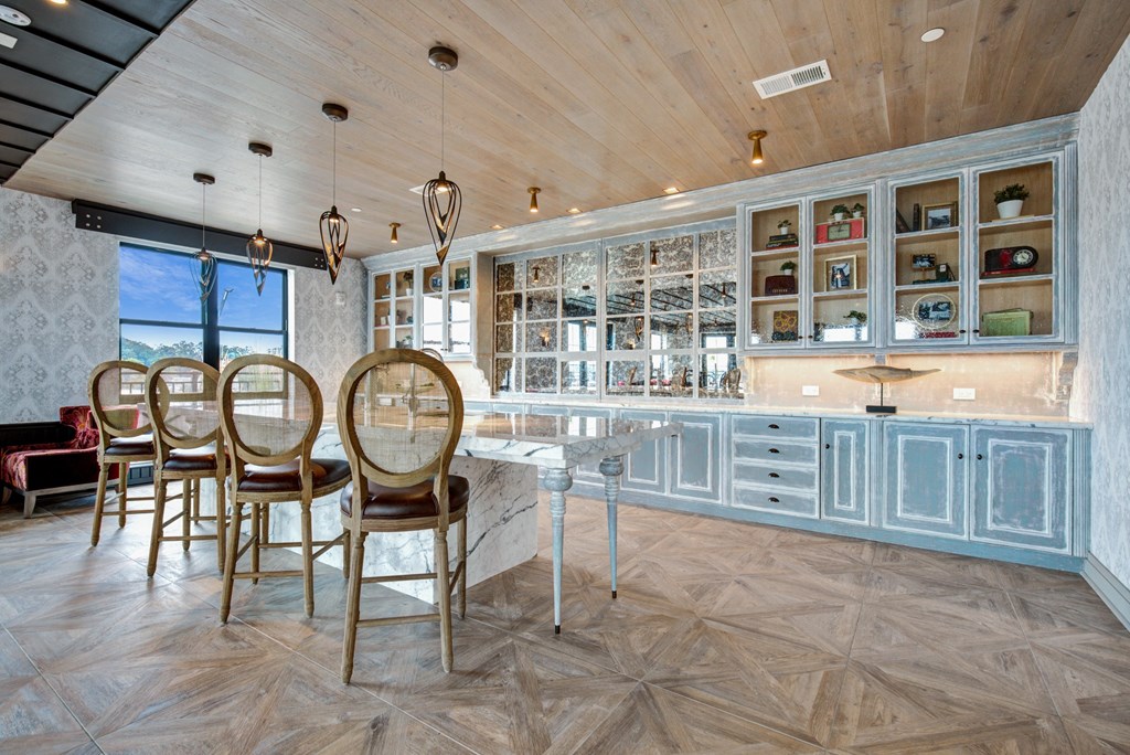 a kitchen with blue cabinets and a table with chairs at Coda at Bryant Street, District of Columbia, 20002