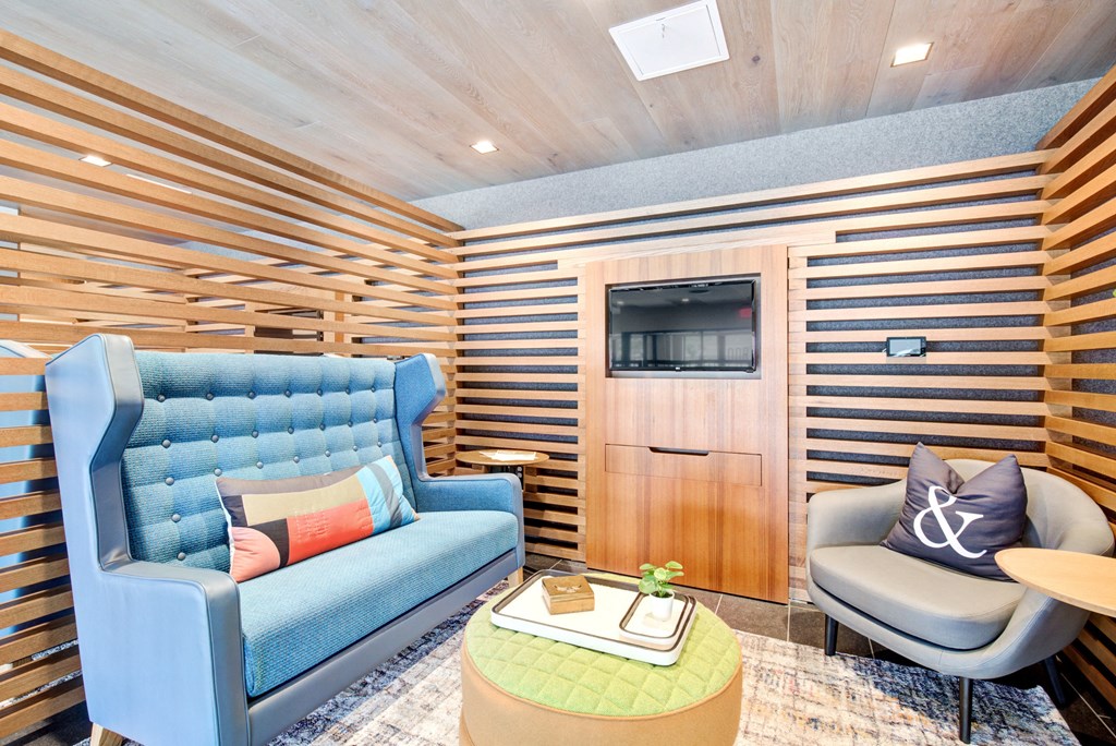 a living room with a blue couch and a tv at Coda at Bryant Street, District of Columbia, 20002