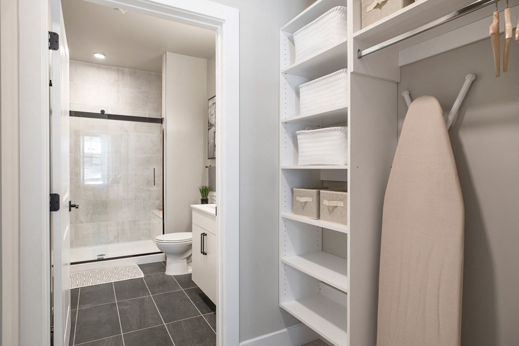 a bathroom with a shower and a towel rack in a closet at Coda at Bryant Street, Washington, DC 20002