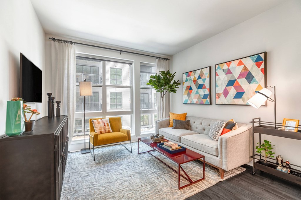 a living room with a couch and a tv at Coda at Bryant Street, District of Columbia