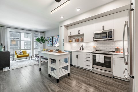 a kitchen with white cabinets and stainless steel appliances
