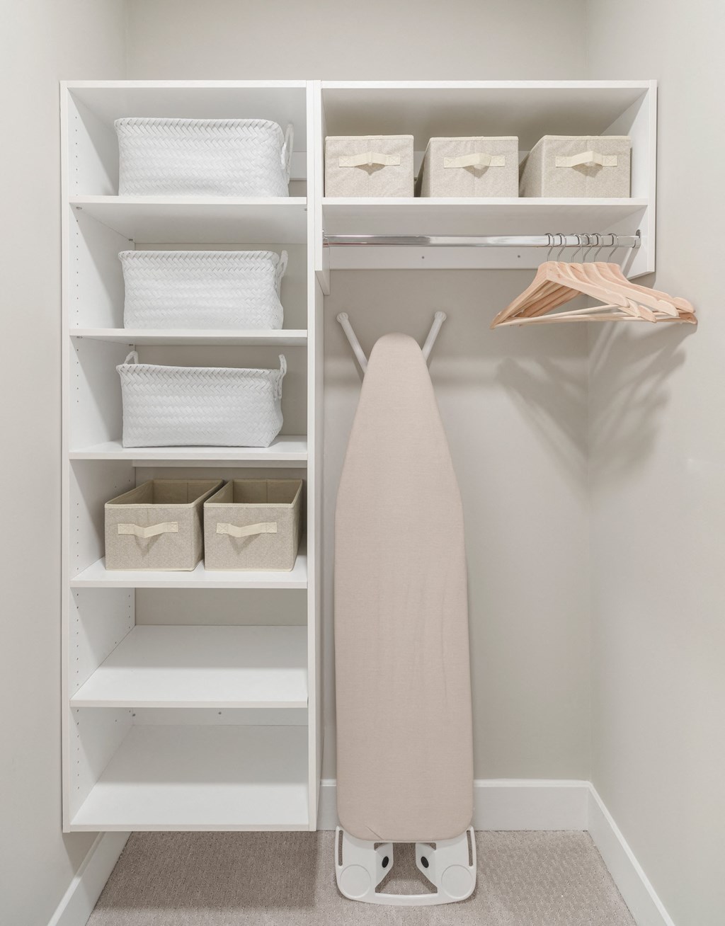 a walk in closet with shelves and a white dresser with a white towel rack at Coda at Bryant Street, Washington, 20002