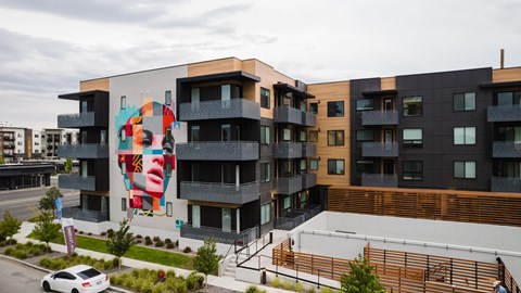 A modern building with a large mural on the side.