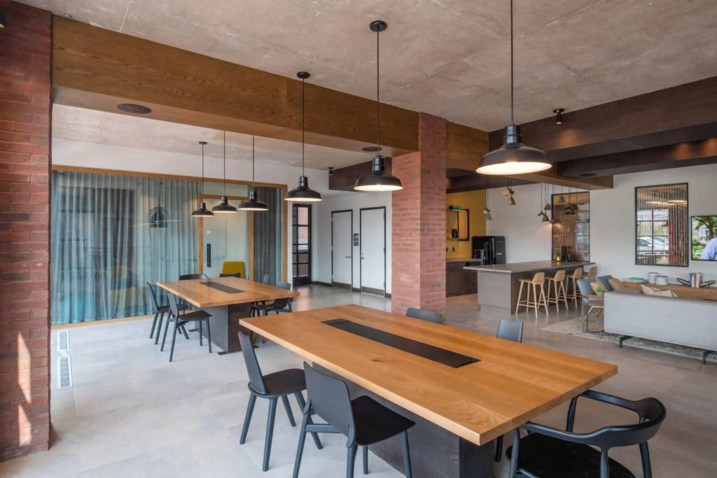 a living room and dining room with wooden tables and chairs