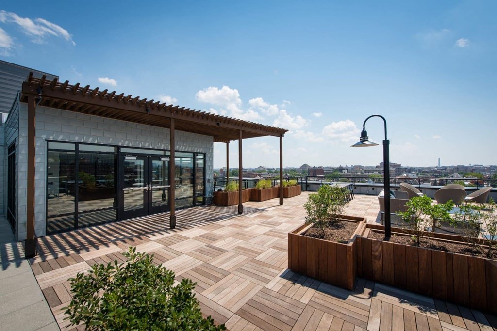 a roof terrace with a view of the city