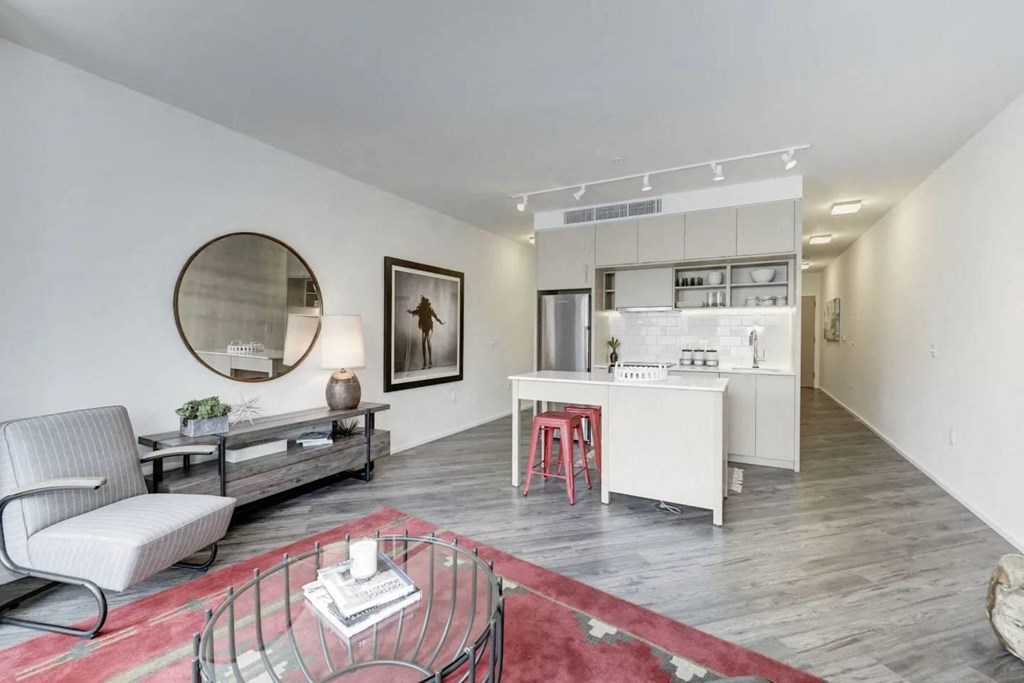 a living room with a couch and a table and a kitchen