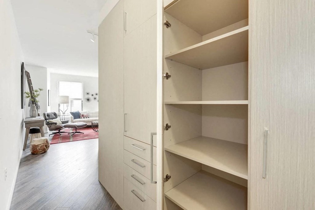 a large white closet with shelves in a living room