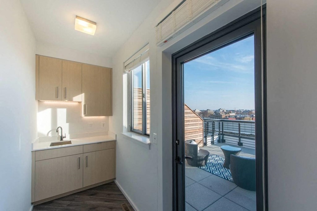 a kitchen or kitchenette with a door to a balcony