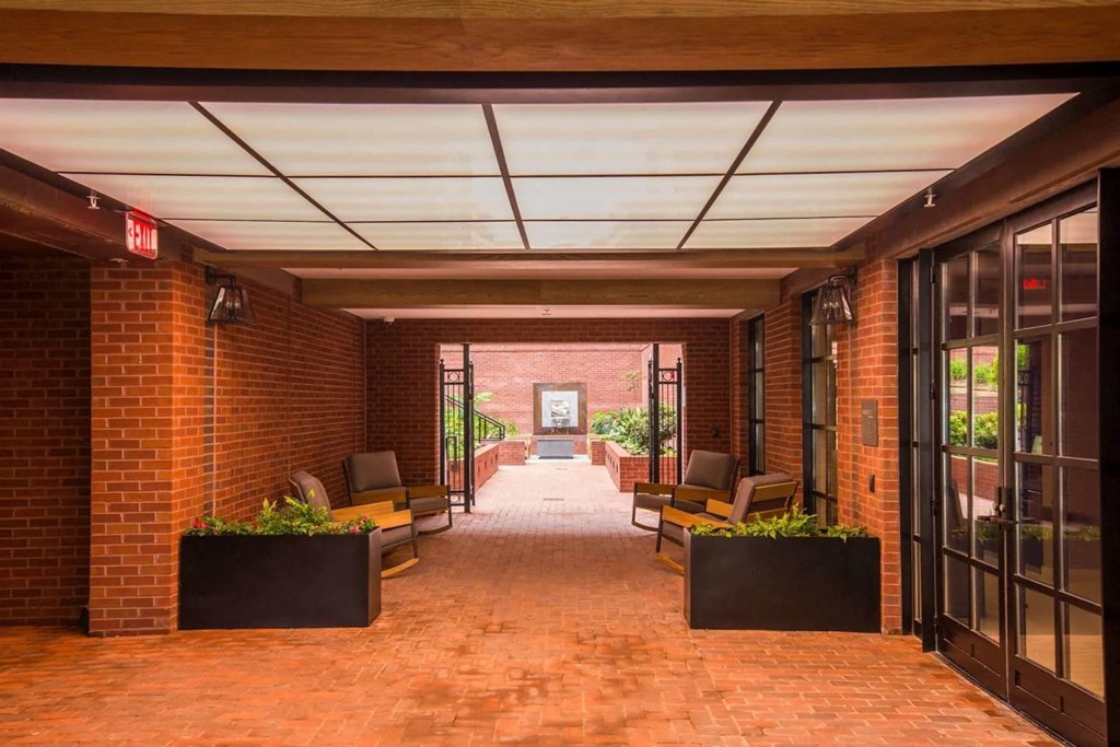the lobby of a building with brick walls and glass doors