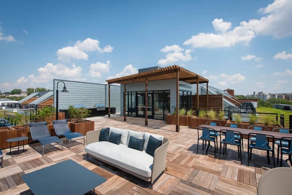 a roof terrace with a couch and tables