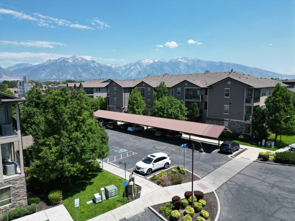 A car is parked in a parking lot in front of a building.at Florentine Villas, Midvale, 84047