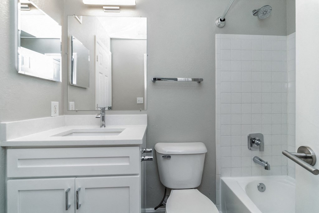 a white bathroom with a toilet and a sink at The Fields at Lorton Station, Lorton, VA