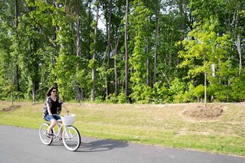 A Woman Rides a Bicycle at The Aster Apartments, Cary, North Carolina