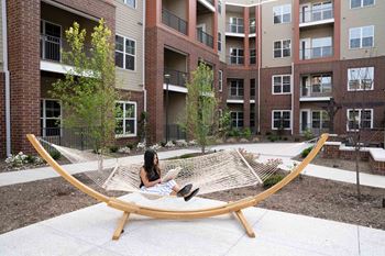 A Woman on a Hammock in a Courtyard at The Aster Apartments, Cary, NC