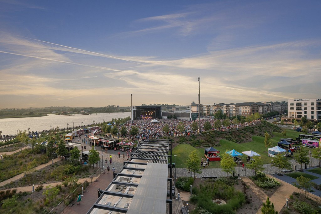 a large crowd of people in front of a large scoreboard and a body of water at Metropolitan at the Riverwalk, Wilmington, NC 28401
