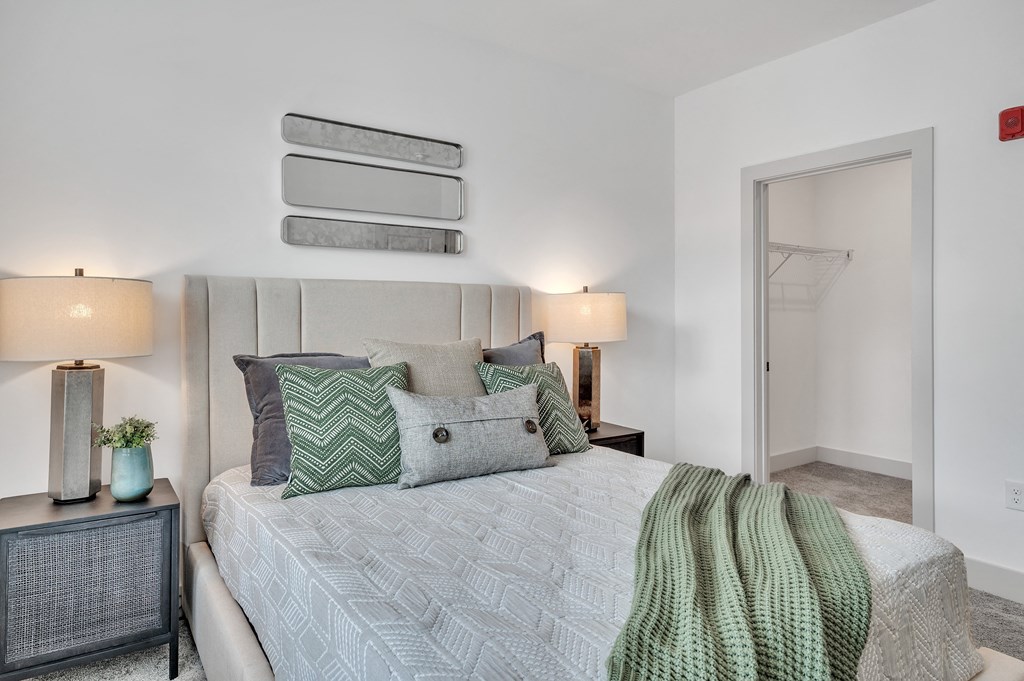 a bedroom with a large bed and pillows at the Riverwalk, Wilmington, NC 28401