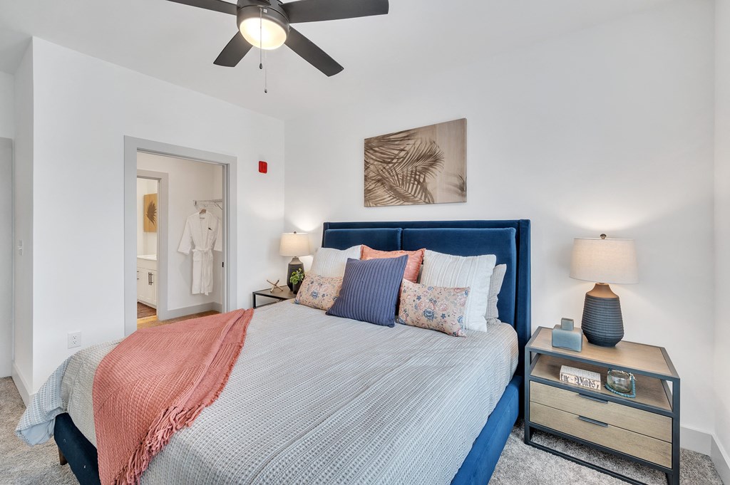 a bedroom with a large bed and a ceiling fan at the Riverwalk, Wilmington, NC