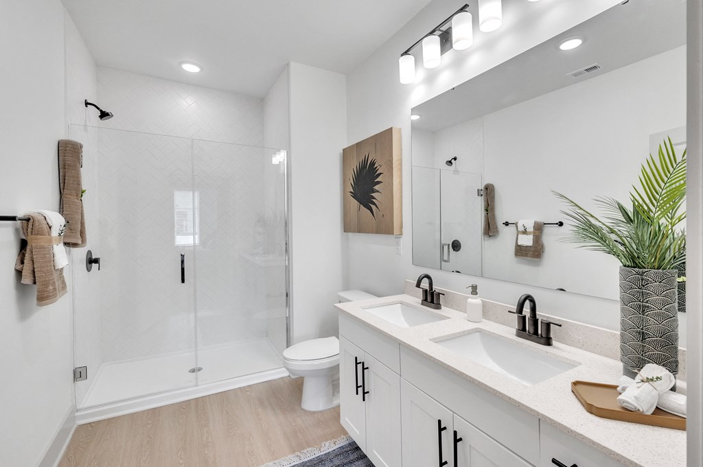 bathroom with double vanity sink and walk-in shower at the Riverwalk, Wilmington, North Carolina