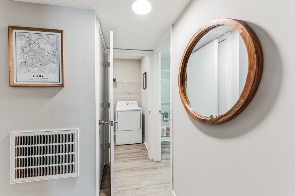 a bathroom with a white washer and dryer and a mirror on the wall  at Brampton Moors, North Carolina