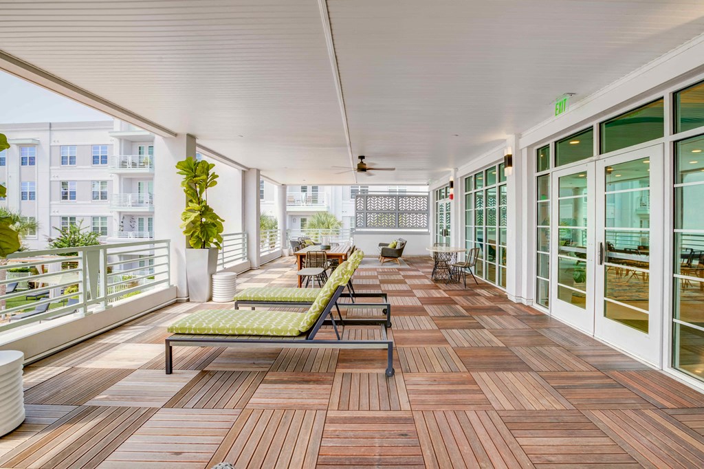 a large porch with wood floors and glass doors at Delamarre at Celebration, Celebration, 34747