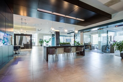 A modern dining area with a long table and chairs.