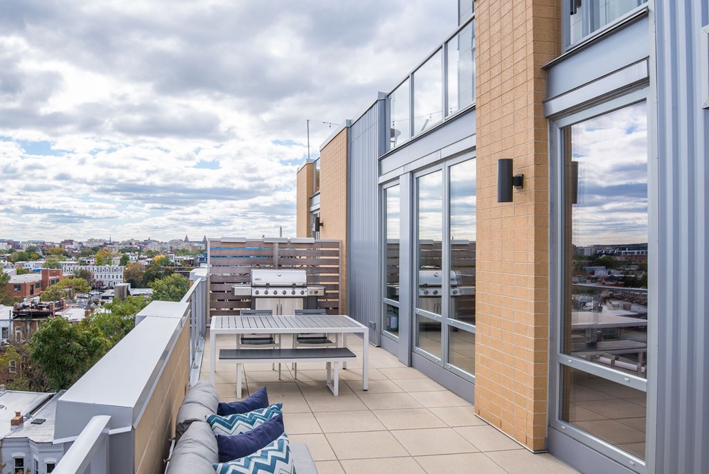 A balcony with a table and chairs overlooking a cityscape.at Elysium Fourteen, Washington, District of Columbia
