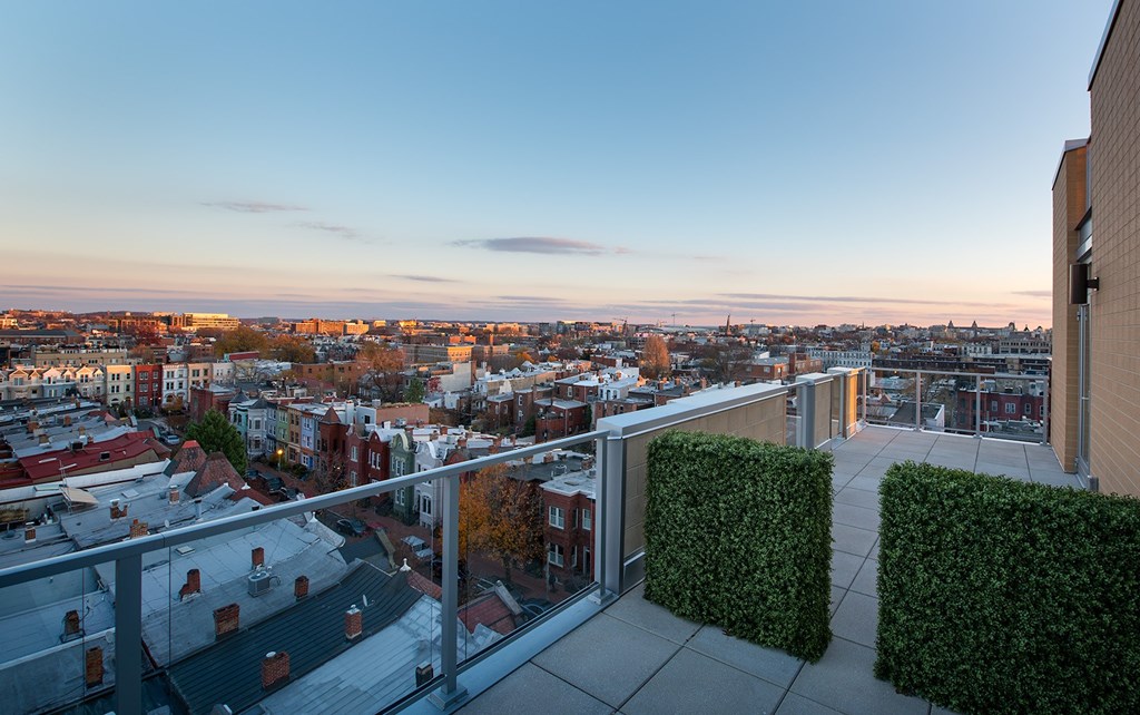 A balcony overlooks a cityscape at sunset.at Elysium Fourteen, Washington, DC