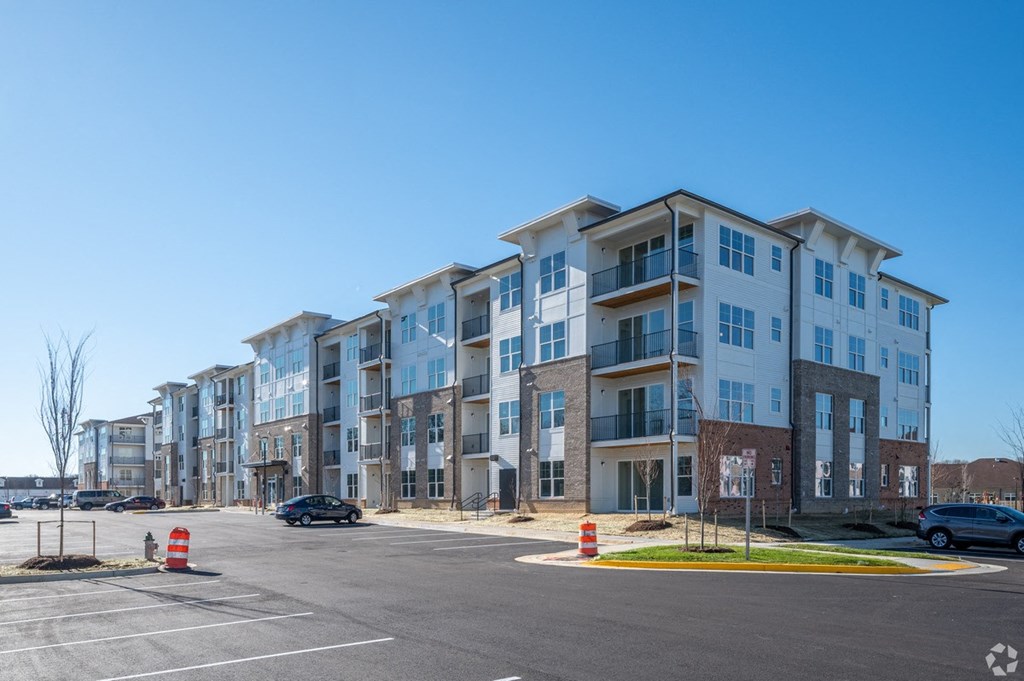 a large apartment building on the corner of a parking lot at Fairmont at South Lake, Maryland, 20716
