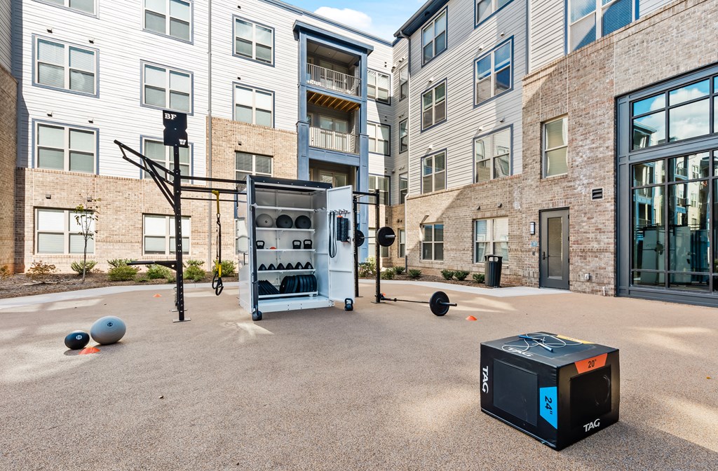 Outdoor fitness center with free weights at Preston Ridge Apartments in Cary, NC.