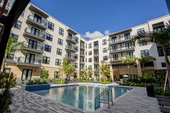 a swimming pool in front of an apartment building at La Unión, Florida