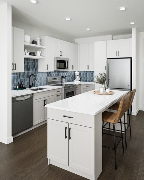 A modern kitchen with white cabinets and a marble countertop.