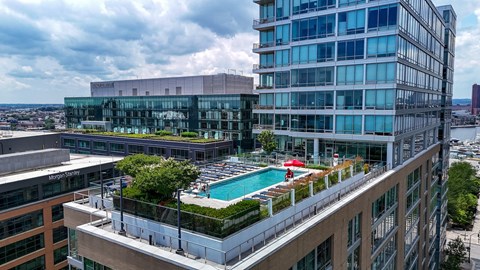 A modern building with a pool on the roof.