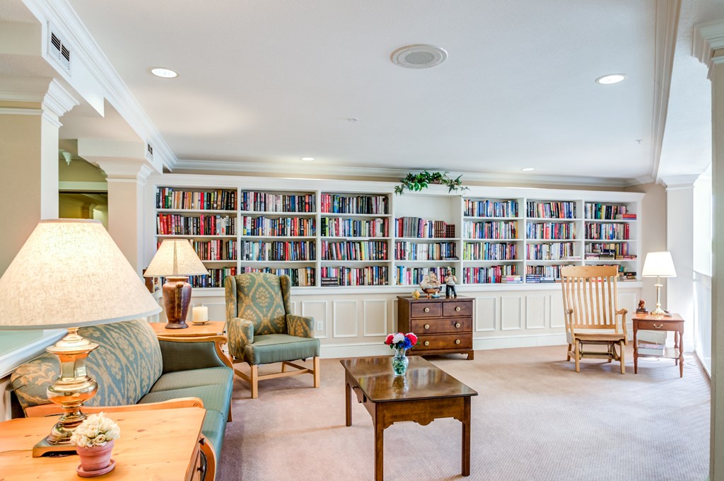 a living room filled with furniture and a book shelf