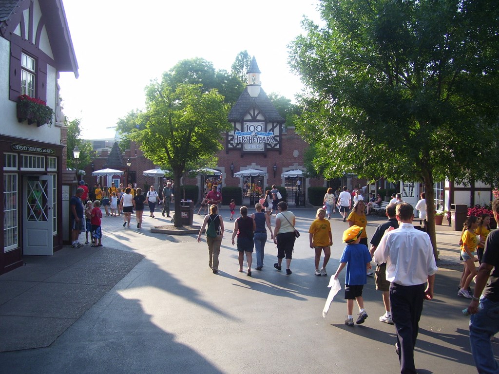 a crowd of people walking down a street in front of a building