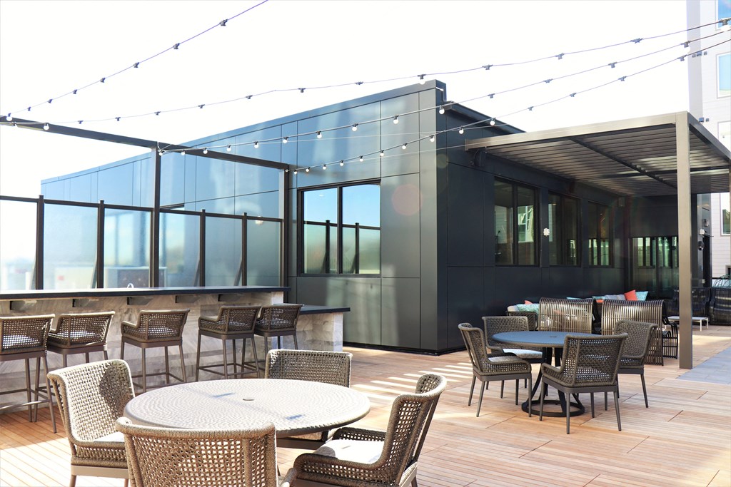 an outdoor patio with tables and chairs and a bar at Vyne One Loudoun, Ashburn, VA, 20147