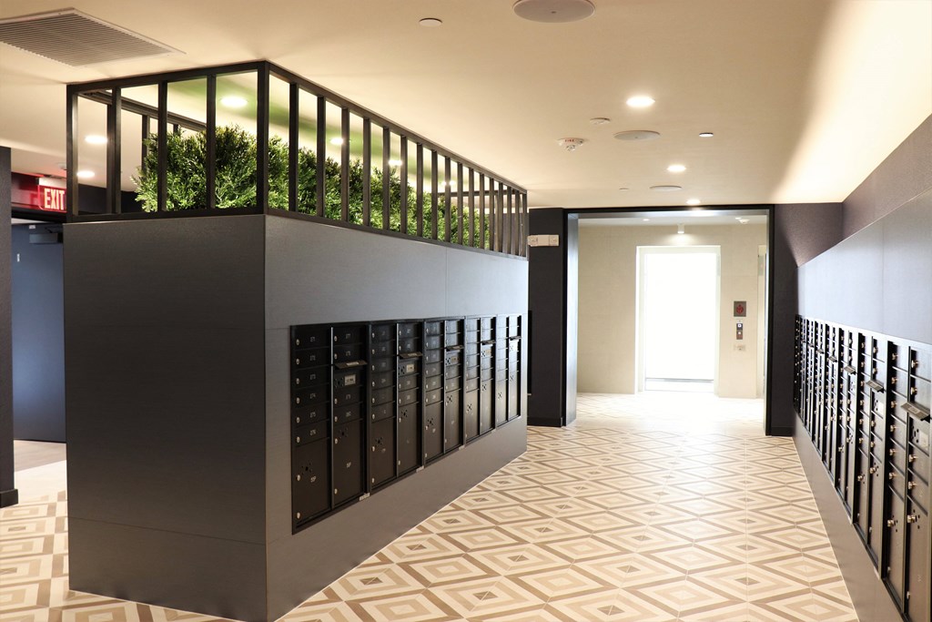 a view down the hallway of a building with a plant box on the top of the wall at Vyne One Loudoun, Ashburn, Virginia