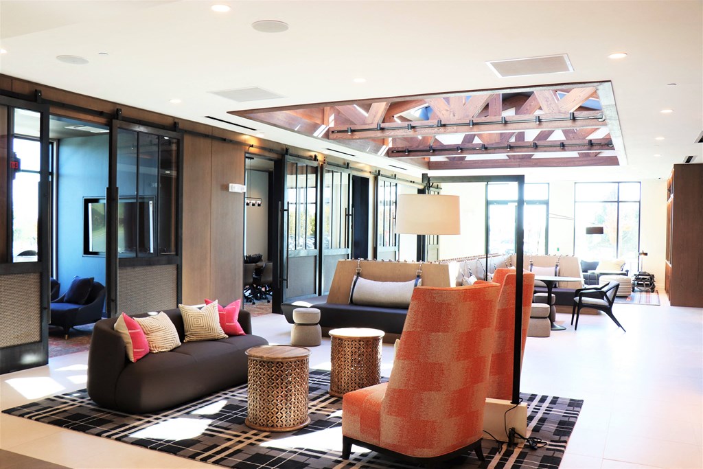 a living room filled with furniture and a large window at Vyne One Loudoun, Virginia