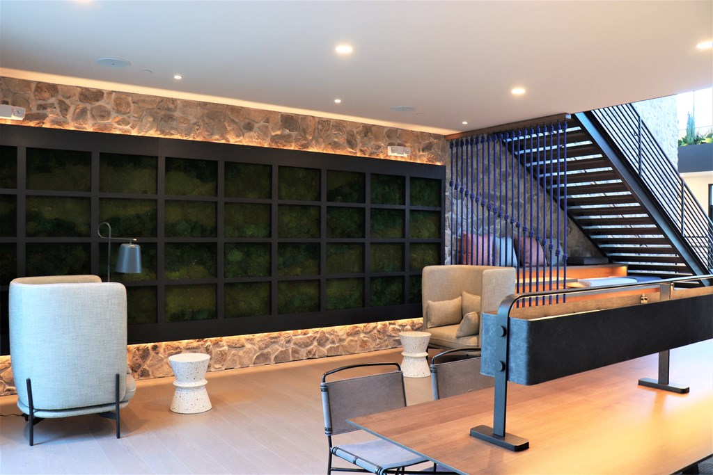 a view of the lobby with a large black wall and a staircase with black metal railings at Vyne One Loudoun, Virginia