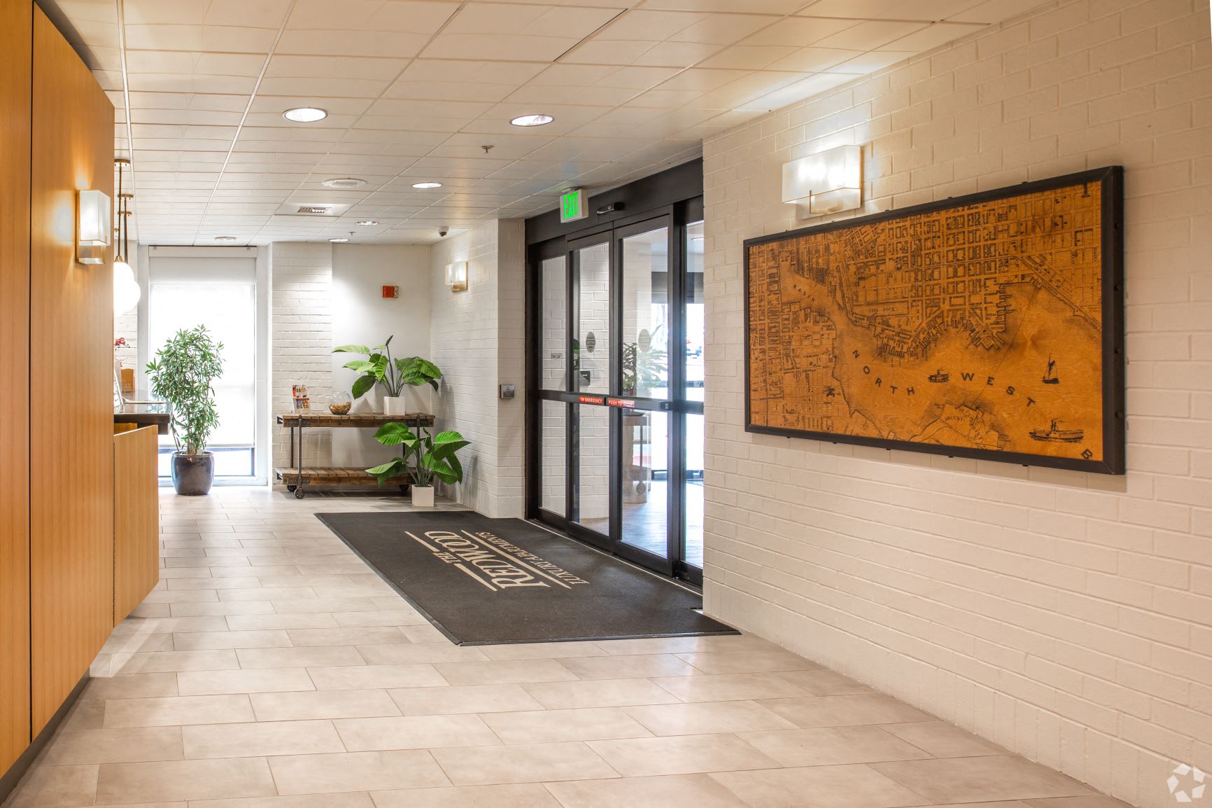 a map of the area hangs on the wall at the front of the building  at The Redwood, Baltimore, MD, 21201