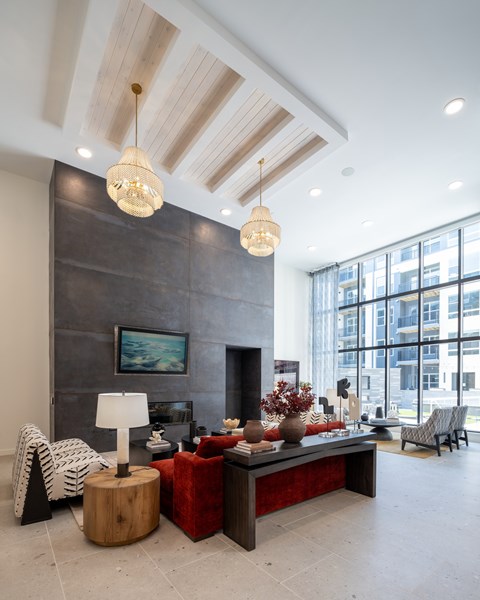 A modern living room with a fireplace and a large painting on the wall.