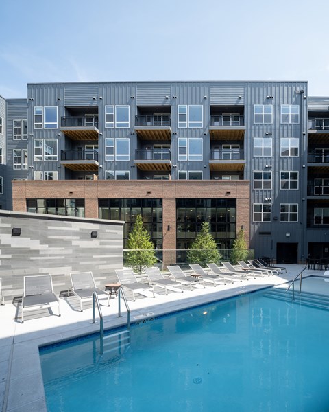 A modern building with a pool in front at The Sully Apartments, Chantilly, VA, 20151