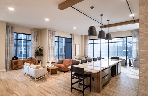 A modern kitchen with a dining table and chairs.