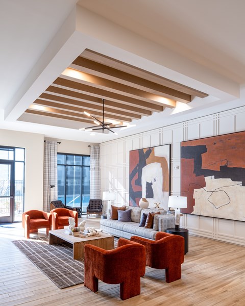 A living room with a large painting on the wall and a wooden floor.